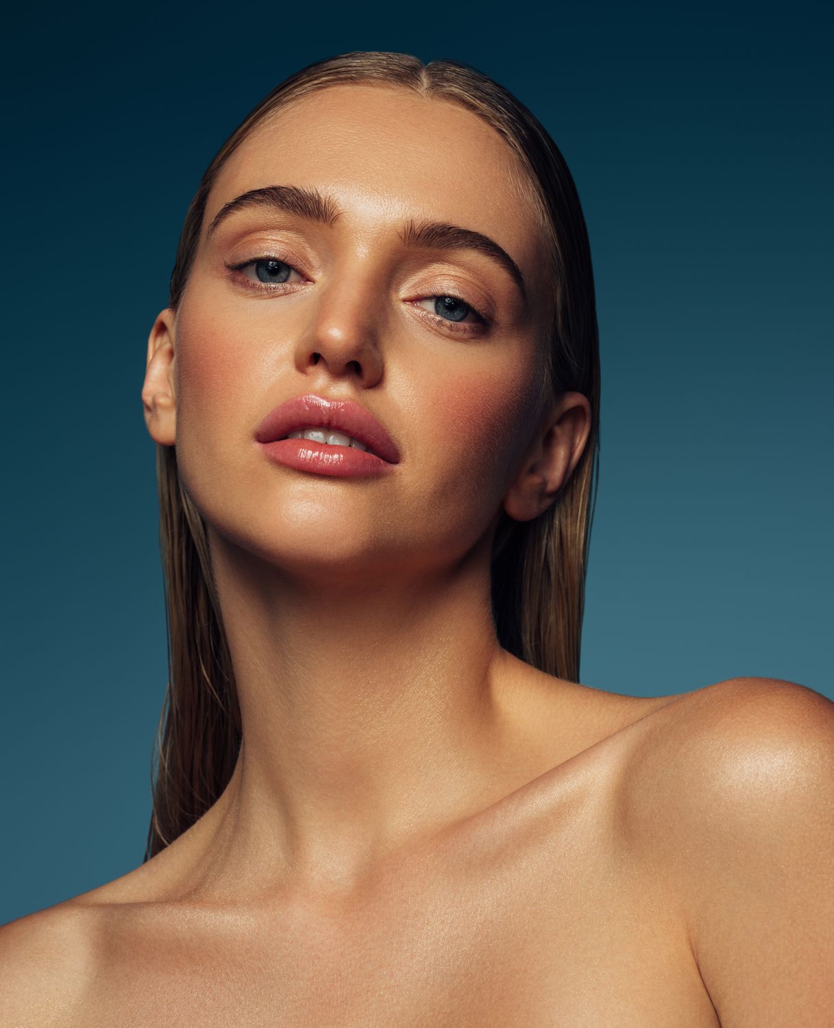 Close-up portrait of a woman with wet hair.