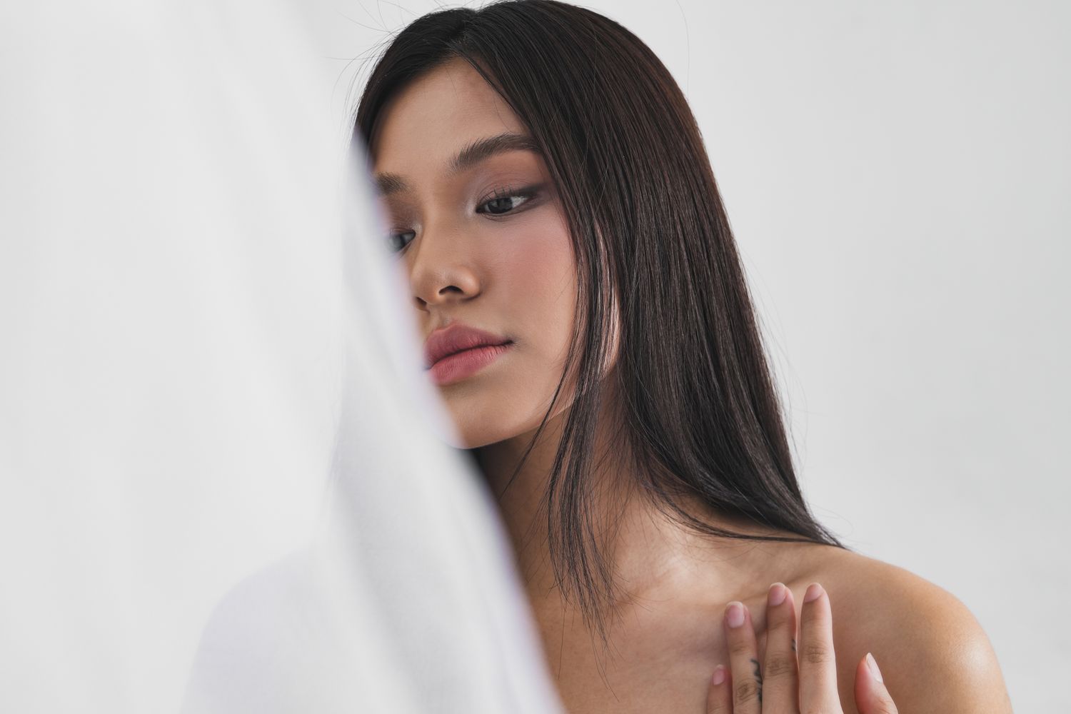 Woman with long hair gazing thoughtfully.